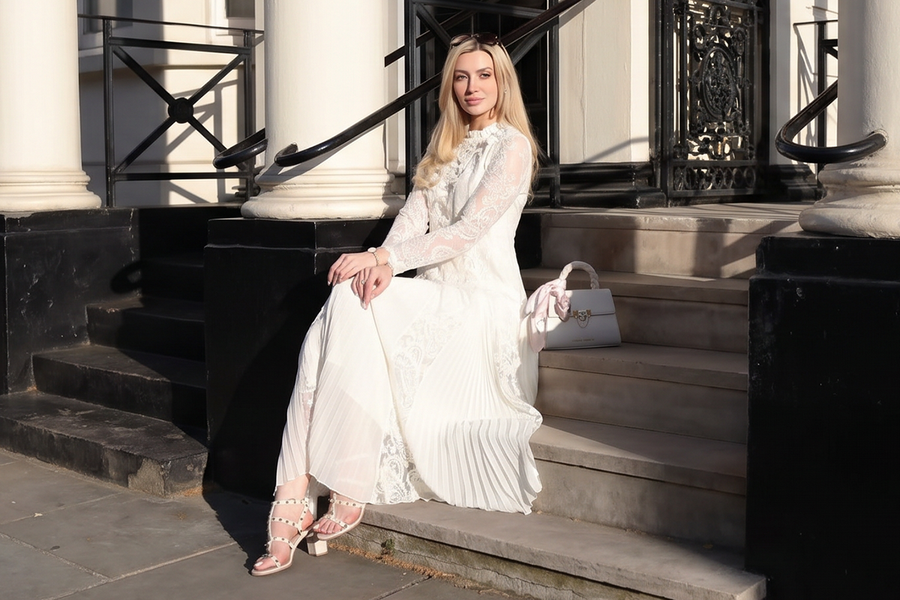 richradiqs white lace maxi dress on city steps