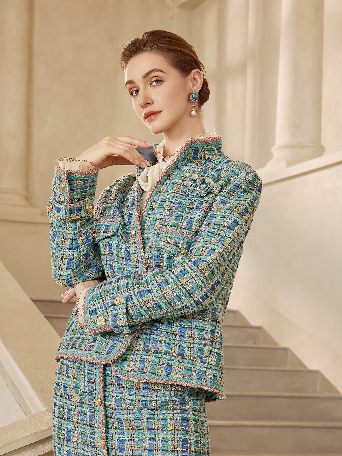 Elegant woman in a blue tweed blazer and matching skirt with textured woven details