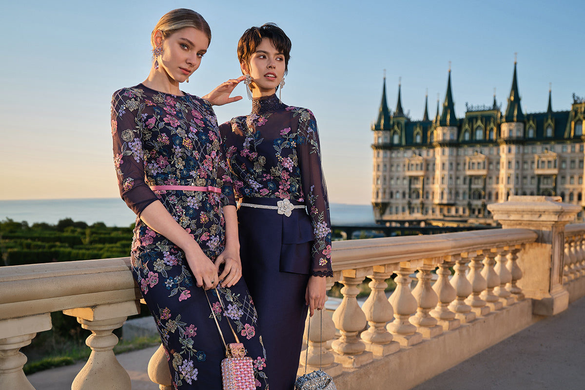 Women wearing floral embroidered rooftop party outfits at sunset