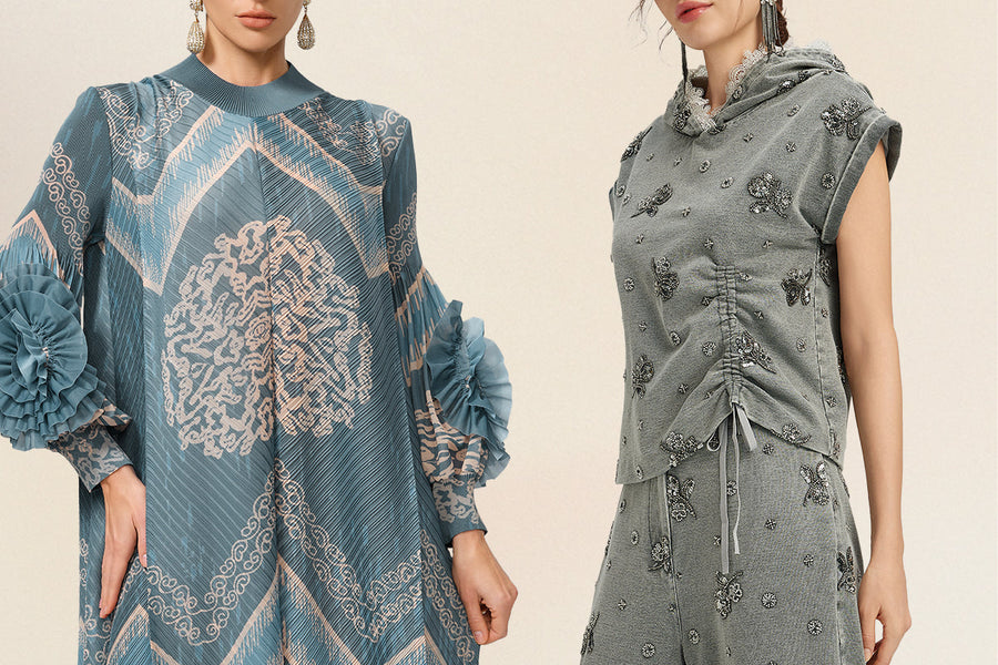 Two women modeling elegant modest fashion, featuring a blue pleated patterned dress and a gray embellished hooded top with matching pants.