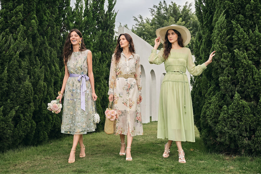 Women in a garden wearing elegant wedding guest dresses with floral and pastel designs.