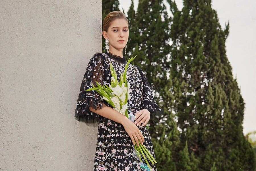 richradiqs black floral embroidered dress in an outdoor garden scene