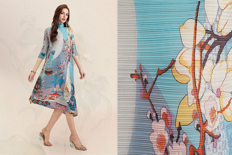 Fine accordion pleated dress with floral art print and close-up fabric texture detail.