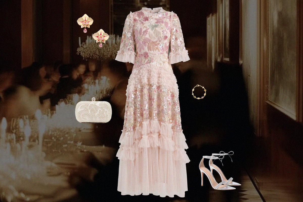 Pink floral embellished cocktail dress styled with heels, earrings, and an evening clutch