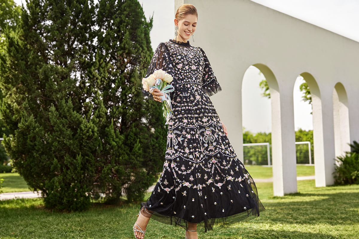 Woman wearing a flowing maxi dress styled with coordinating shoes