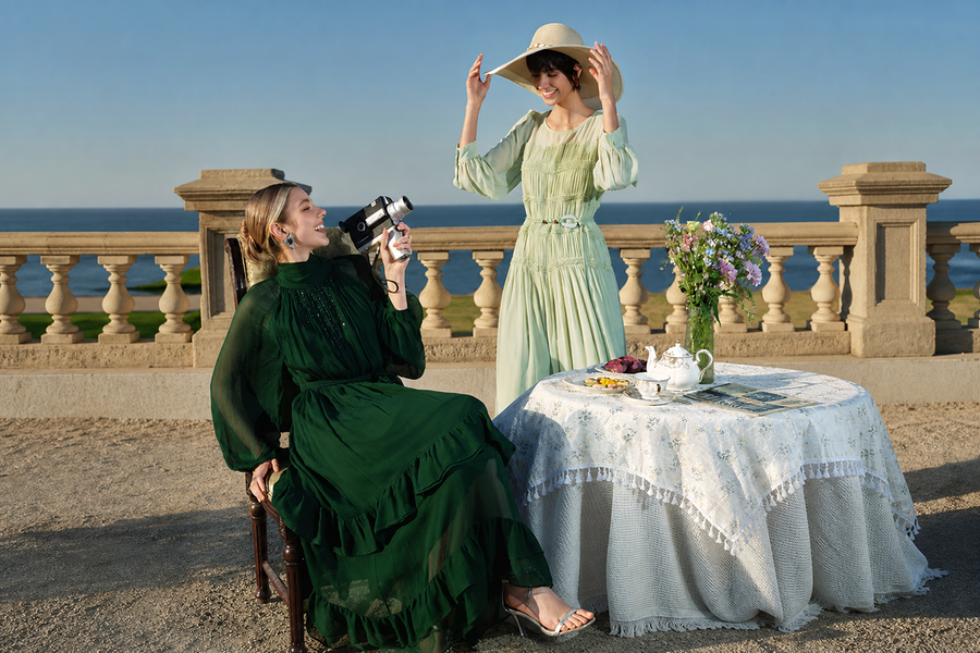 Women in green dresses at outdoor tea party
